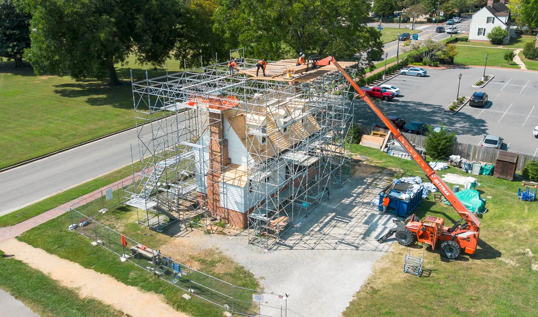 Scaffolding covering a white structure