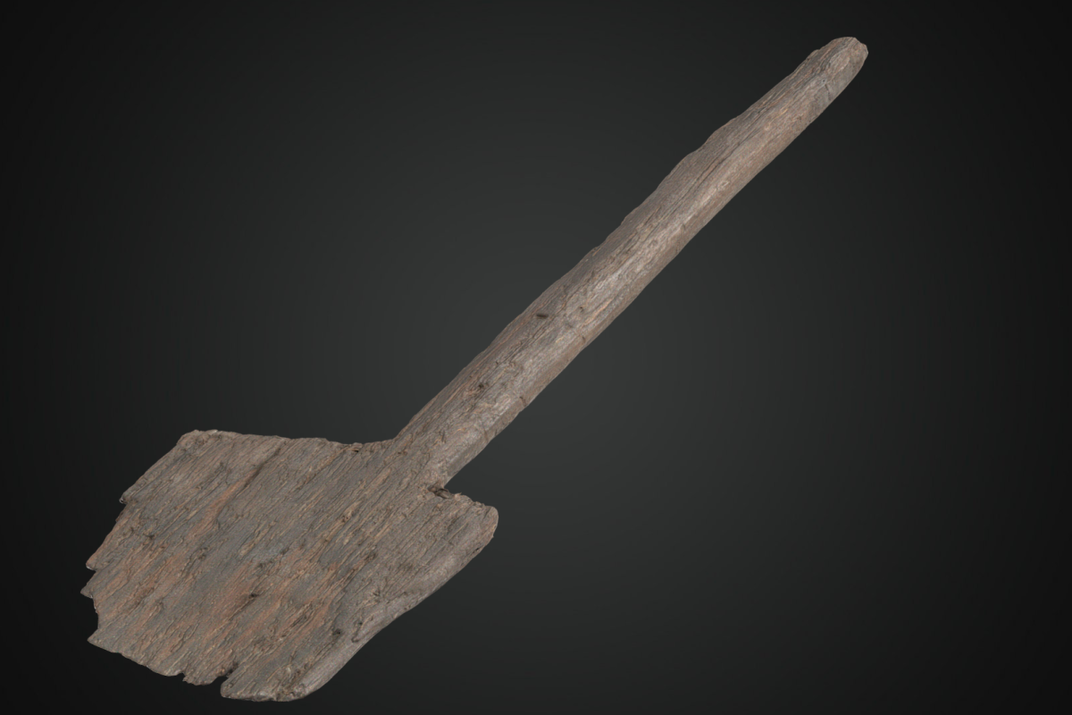 Wooden shovel against a black backdrop